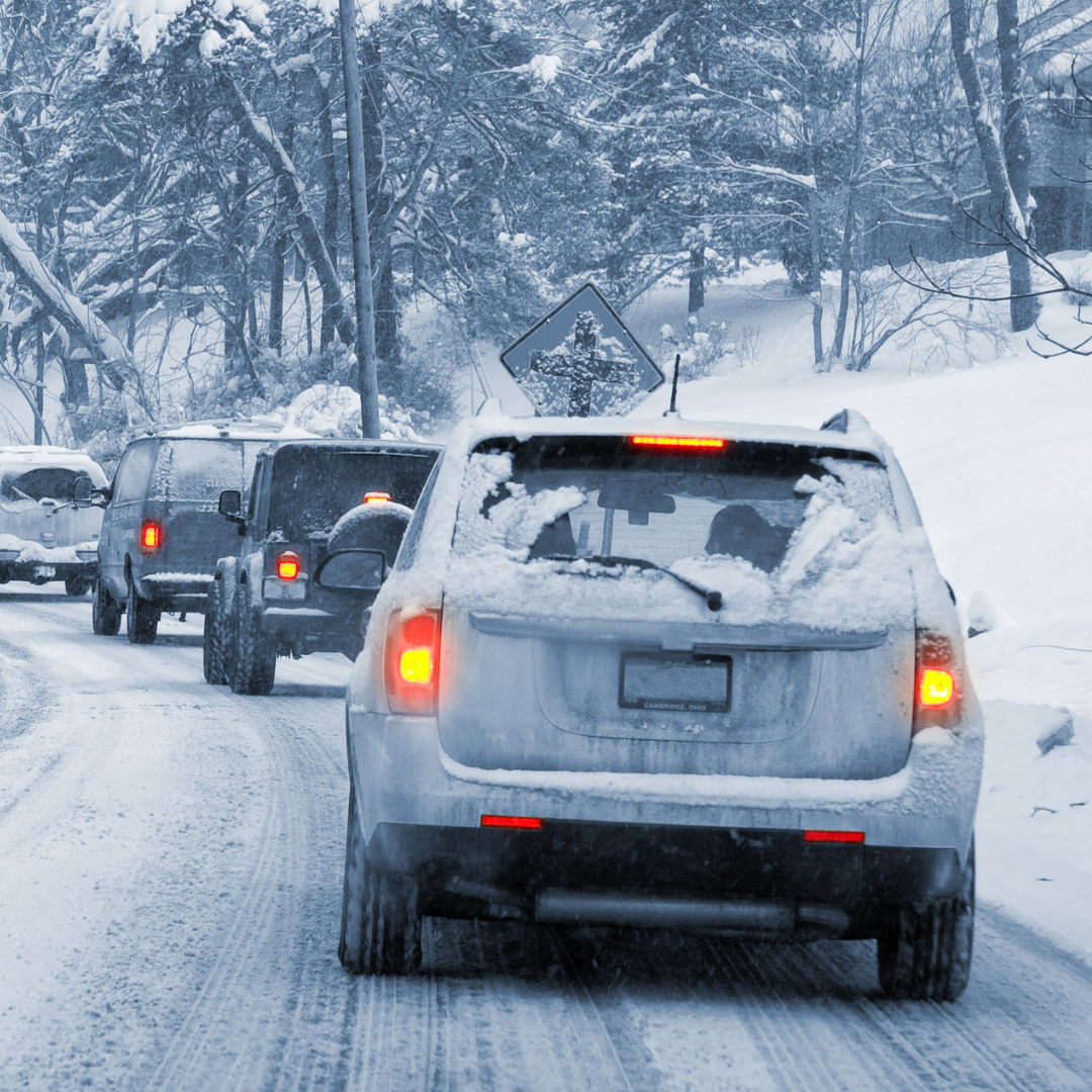 A group of Auto Draft vehicles driving down a snowy road.