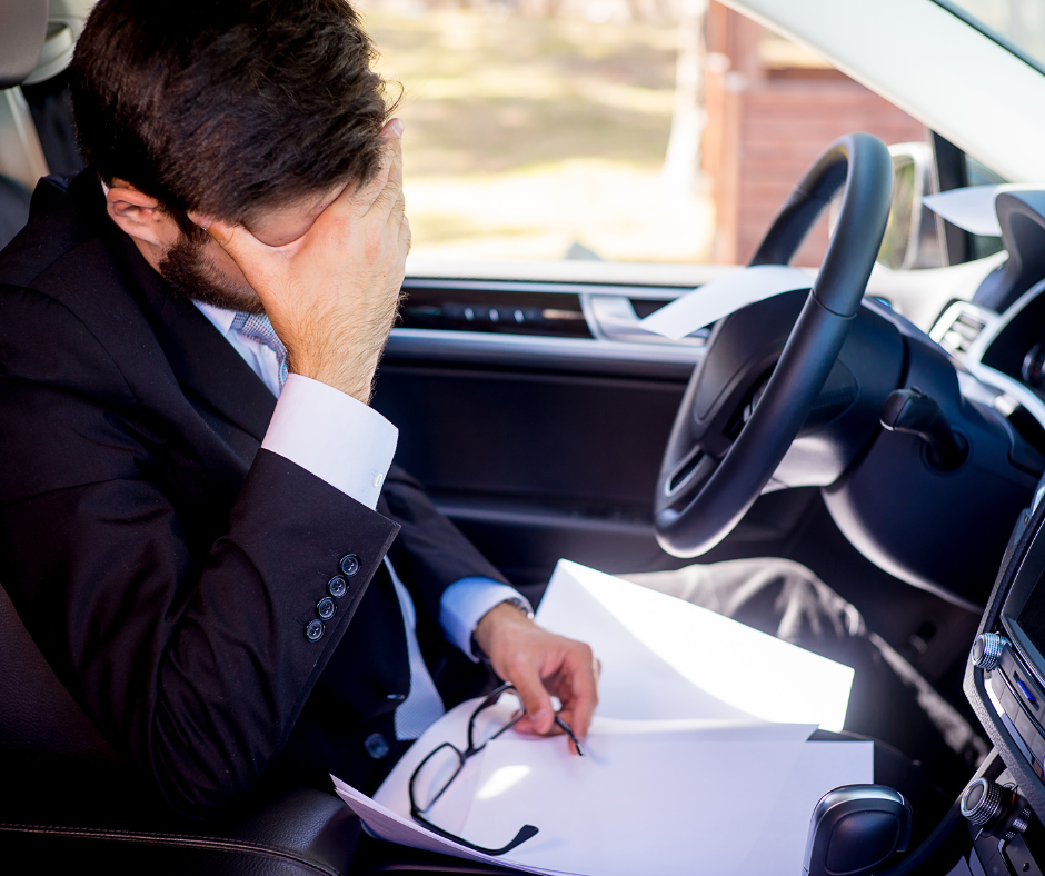7 Ways to De-stress in Your Car: A man in a suit finding relaxation.